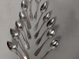 a lot of spoons arranged in a circle on the table