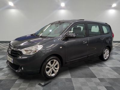the grey van is parked in the garage on a checkered floor