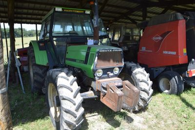 a tractor that is parked next to a trailer
