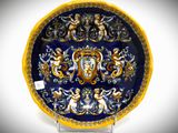 a blue and yellow plate with a design on it