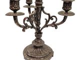 a metal candelab with three candles on it