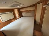 a small bed in the middle of a small room