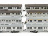 two trains that are sitting side by side on a white surface