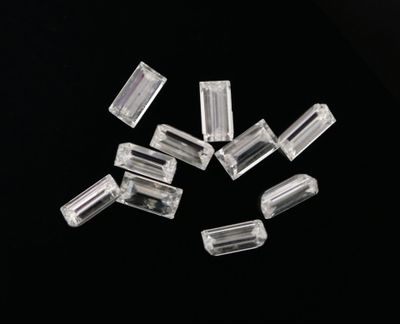 a close up of a bunch of clear glass beads on a black surface