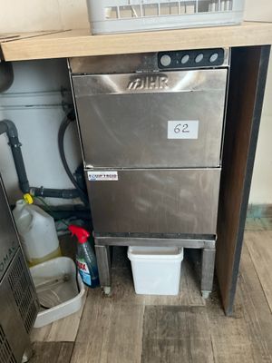 a dishwasher that is in the corner of a kitchen