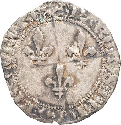 a close up of a silver coin with a face on it