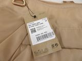 beige pants with a tag on the back of it