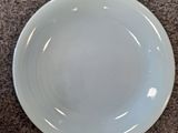 a plate and a bowl sitting on the floor