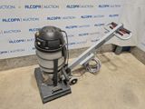 the vacuum is sitting on the floor in front of the wall