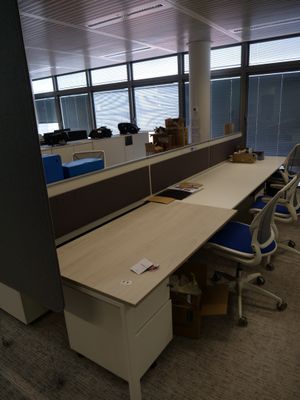 un bureau avec une chaise et un ordinateur posé dessus, dans un bureau