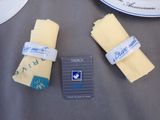 three pieces of cheese sitting on a table next to a card