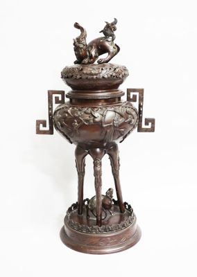 bronze statue of a dog and a cat on a pedestal