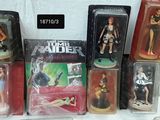 a lot of action figures on display in a display case