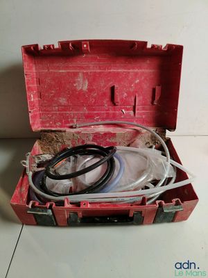 a red box with wires and a hose in it
