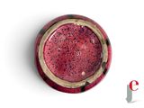 a red and black bowl on a white surface