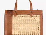 a brown and white bag with a brown handle and handles