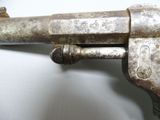 a gun that is sitting on a white surface