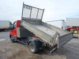 a red truck with a metal bed parked in a parking lot