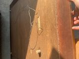 a hand that is reaching for a piece of wood