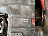 a close up of a drill with a red handle