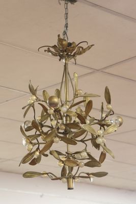 a gold chandelier hanging from the ceiling in a room