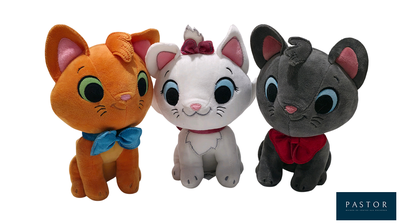 three stuffed animals sitting next to each other on a white background