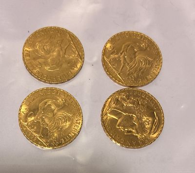 four gold sovereigns on a white background