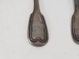 two spoons that are sitting next to each other