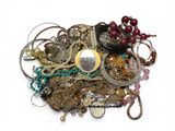 une pile de bijoux assortis sur une surface blanche