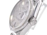 a silver watch that is sitting on a table