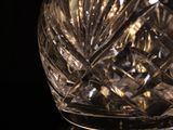 a crystal vase with a black background on the table