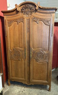 an image of a wooden armoire in a room with a red wall