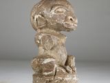 an image of a stone statue of a monkey sitting on top of a rock