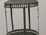 a green metal bird cage on a wooden table