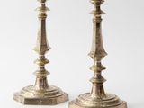 pair of antique brass candlesticks on a white background