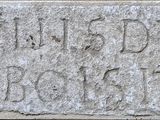a close up of a stone block with writing on it