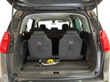 two seats in the back of a car with a yellow object in the trunk