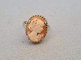 a close up of a ring with a woman ' s face on it