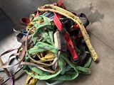 a pile of different colored leashes on the ground