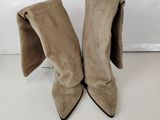 a pair of beige sued boots on a white surface