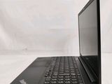 the back of a laptop computer sitting on top of a white table
