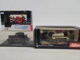 two boxed boxed toys of a motorcycle and a car on a white surface