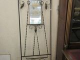 a mirror on a stand in the corner of a room