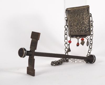 a metal object with a chain and a book on it