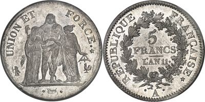 a close up of a coin with a woman and a man on it