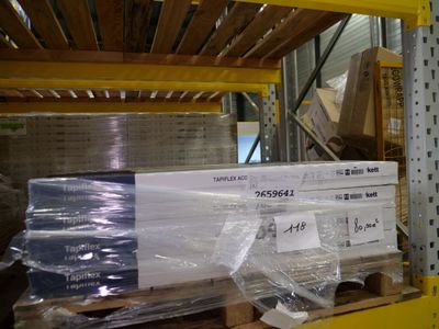 a large stack of boxes on a pallet in a warehouse
