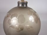 an image of a glass bottle with a flower design
