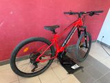 a bike that is sitting on a stand in front of a red wall