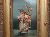 painting of a vase of flowers in a gold frame on a table