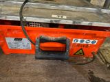 an orange box with a black handle sitting on the floor